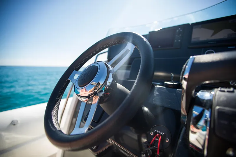 Slide: The Image of Steering wheel of 2025 Zodiac Medline 9 boat with ocean view. - 21