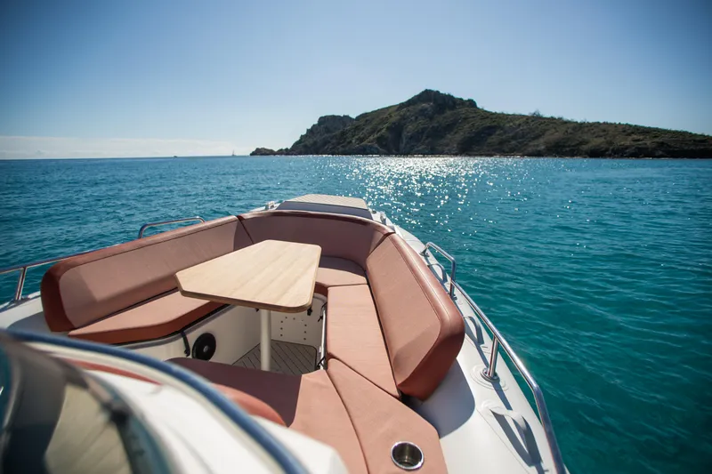 Slide: The Image of Zodiac Medline 9 boat, 2025 model, cruising on clear blue waters near a scenic island. - 22