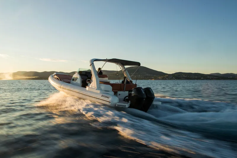 Slide: The Image of 2025 Zodiac Medline 9 boat cruising on open water at sunset. - 24