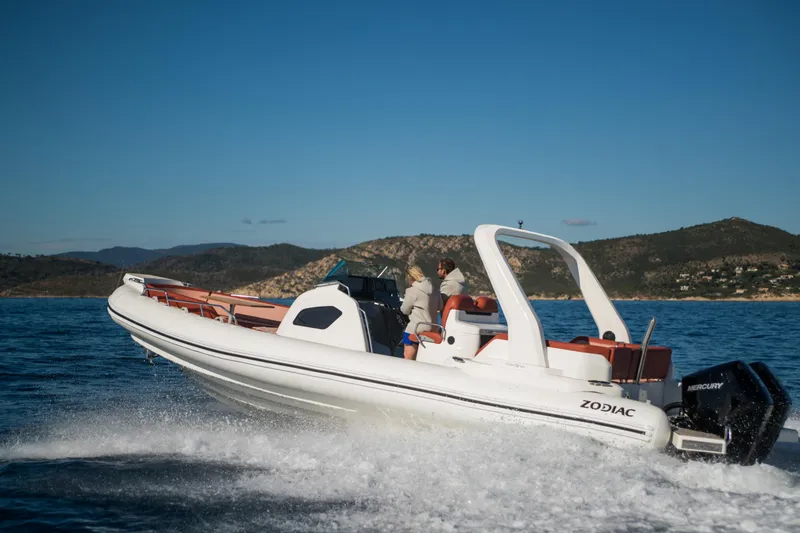 Slide: The Image of 2025 Zodiac Medline 9 boat cruising on open water, scenic coastal backdrop. - 26