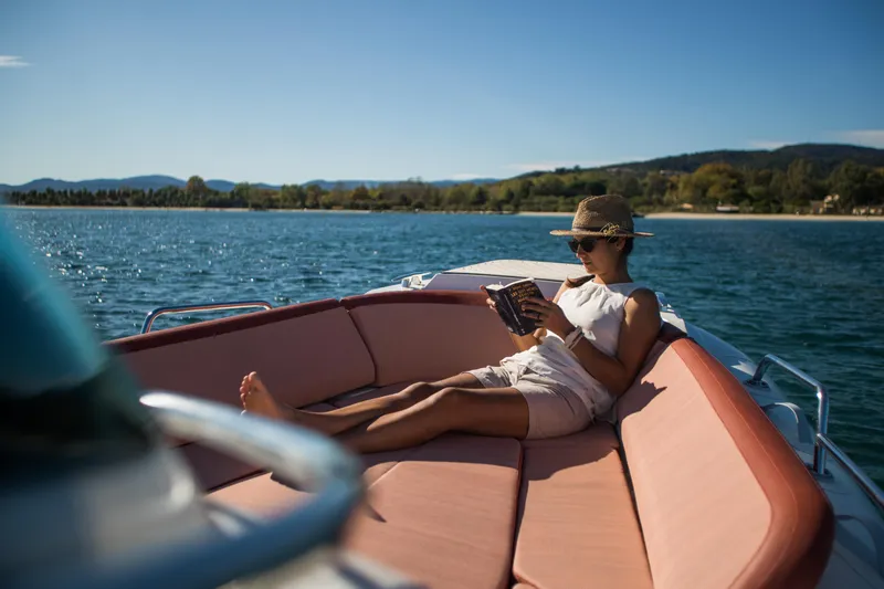 Slide: The Image of Woman relaxing on a 2025 Zodiac Medline 9 boat, reading under the sun. - 9