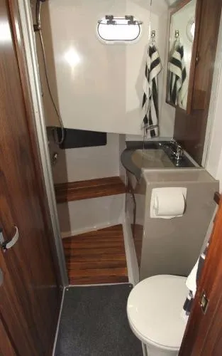 Slide: The Image of 2025 Sargo EXPLORER bathroom with wood accents, compact sink, and toilet. - 10