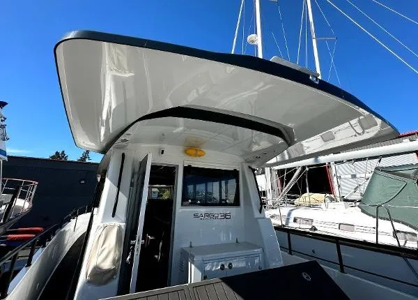 Slide: The Image of 2025 Sargo EXPLORER boat with sleek design and spacious deck under clear blue sky. - 11