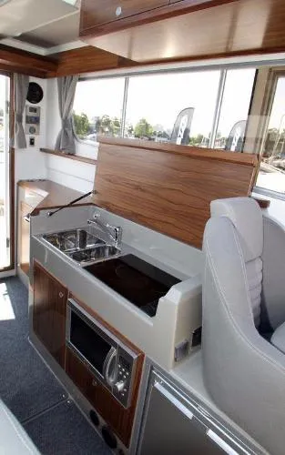 Slide: The Image of Interior of 2025 Sargo EXPLORER boat with modern kitchen and seating area. - 8