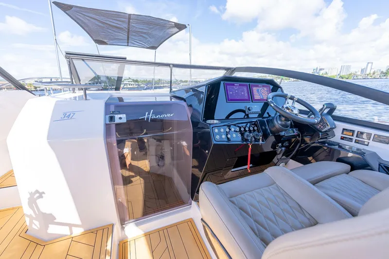 Slide: The Image of 2025 Hanover 347 Outboard boat cockpit with modern controls and luxurious seating. - 12
