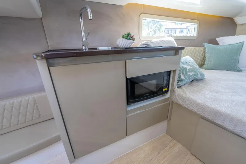 Slide: The Image of Compact kitchen area in 2025 Hanover 347 Outboard boat with sink and microwave. - 16