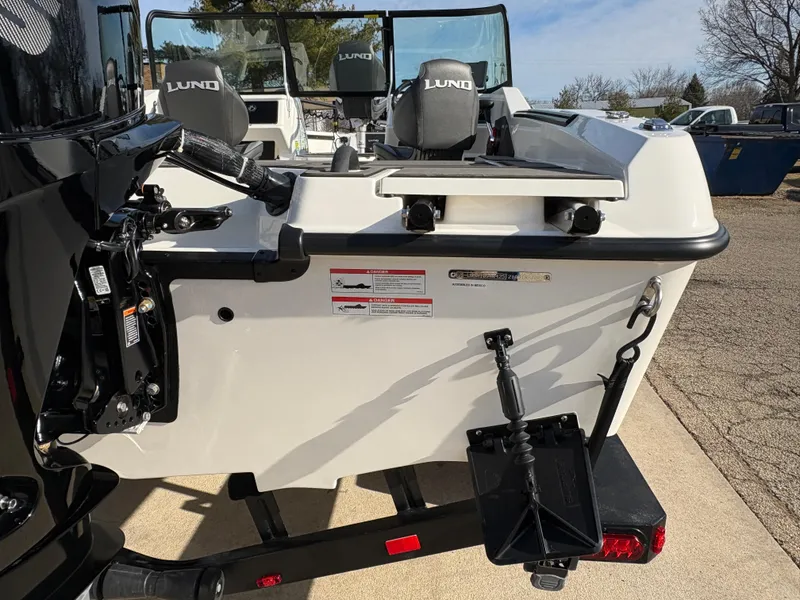 Slide: The Image of 2025 Lund 185 Impact GL boat, rear view, featuring seating and motor mount. - 12