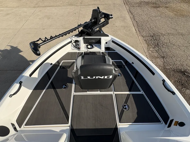 Slide: The Image of 2025 Lund 185 Impact GL boat interior with trolling motor and seating. - 14