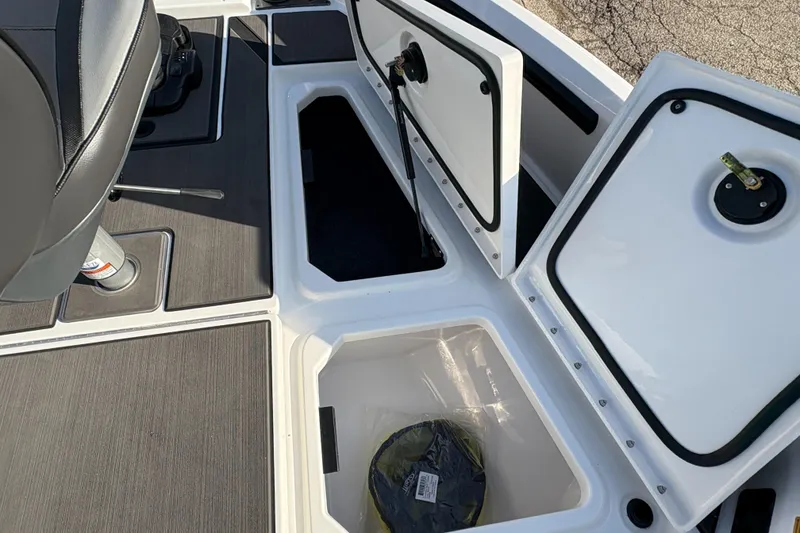 Slide: The Image of 2025 Lund 185 Impact GL boat storage compartments with open hatches. - 17