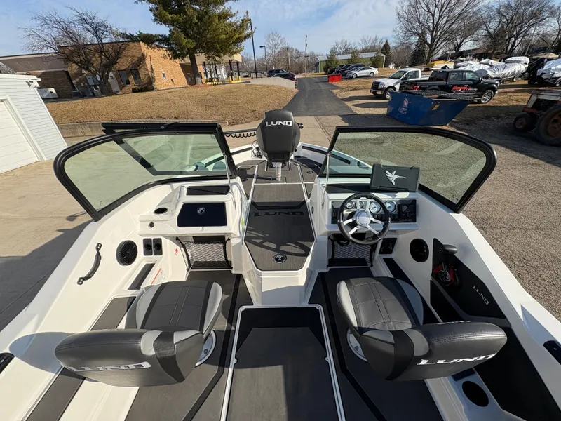 Slide: The Image of 2025 Lund 185 Impact GL boat interior with modern seating and steering console. - 22