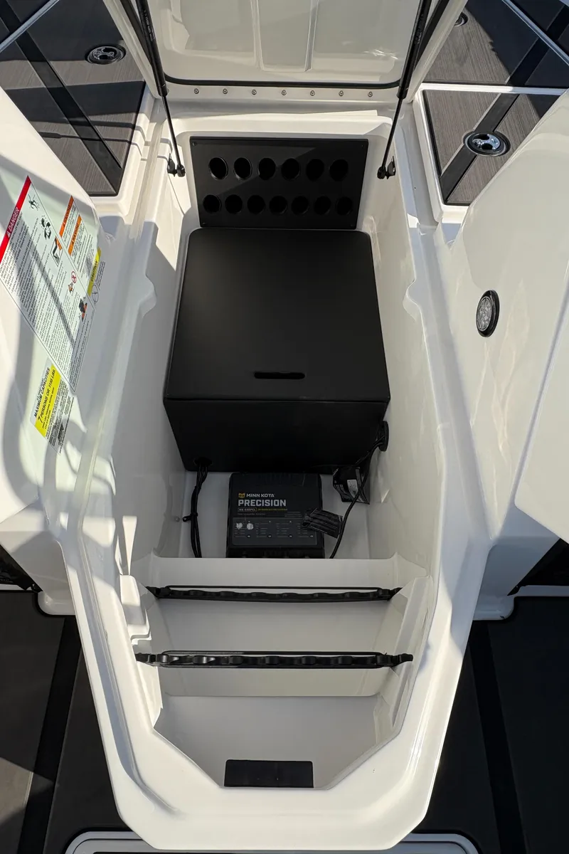 Slide: The Image of 2025 Lund 185 Impact GL boat storage compartment with battery and equipment. - 23