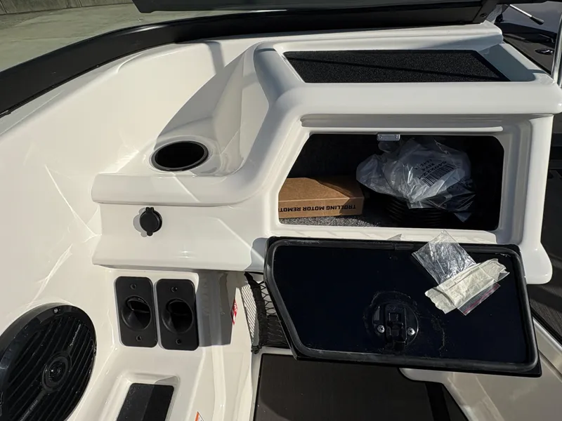 Slide: The Image of 2025 Lund 185 Impact GL boat interior with storage compartment and cup holder. - 25