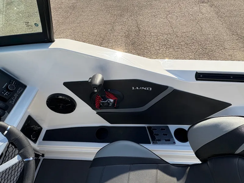 Slide: The Image of Interior view of 2025 Lund 185 Impact GL boat cockpit with steering and controls. - 28
