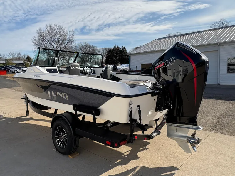 Slide: The Image of 2025 Lund 185 Impact GL boat with powerful outboard motor on a trailer. - 3