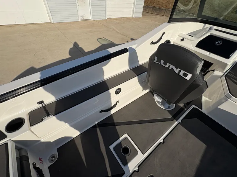 Slide: The Image of 2025 Lund 185 Impact GL boat interior with seating and storage compartments. - 31