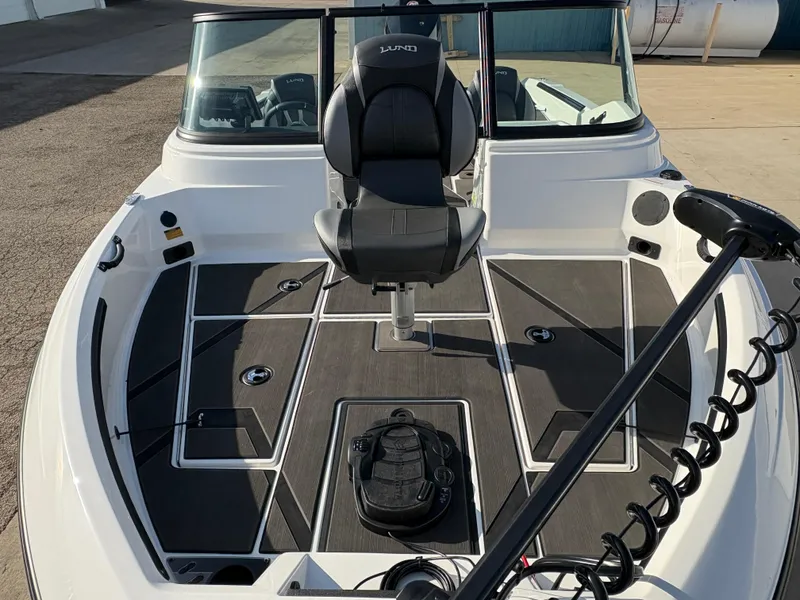 Slide: The Image of 2025 Lund 185 Impact GL boat interior with seating and fishing equipment. - 8