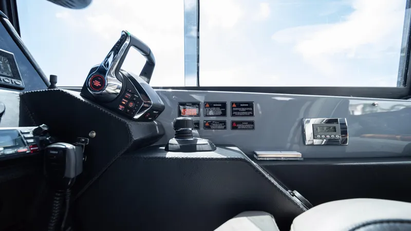 Slide: The Image of Interior view of 2025 Hanover 387 Outboard boat cockpit with modern controls and dashboard. - 14