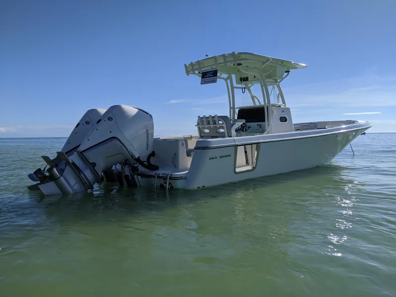 Slide: The Image of 2021 Sea Born LX26 boat on calm water, featuring dual outboard motors. - 1