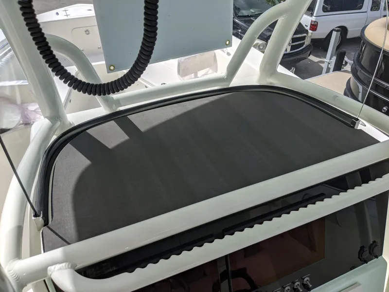 Slide: The Image of 2021 Sea Born LX26 boat dashboard with protective cover and control panel. - 11