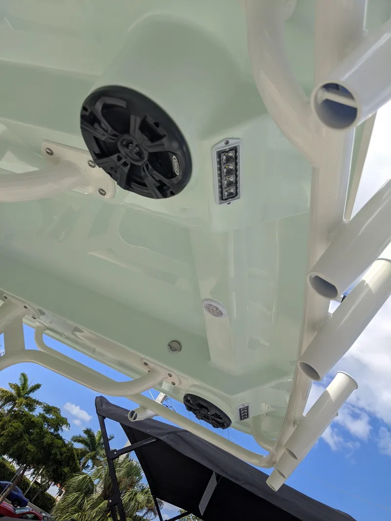 Slide: The Image of 2021 Sea Born LX26 boat with speakers and rod holders under a clear sky. - 13