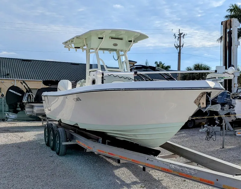 Slide: The Image of 2021 Sea Born LX26 boat on trailer in outdoor setting. - 2