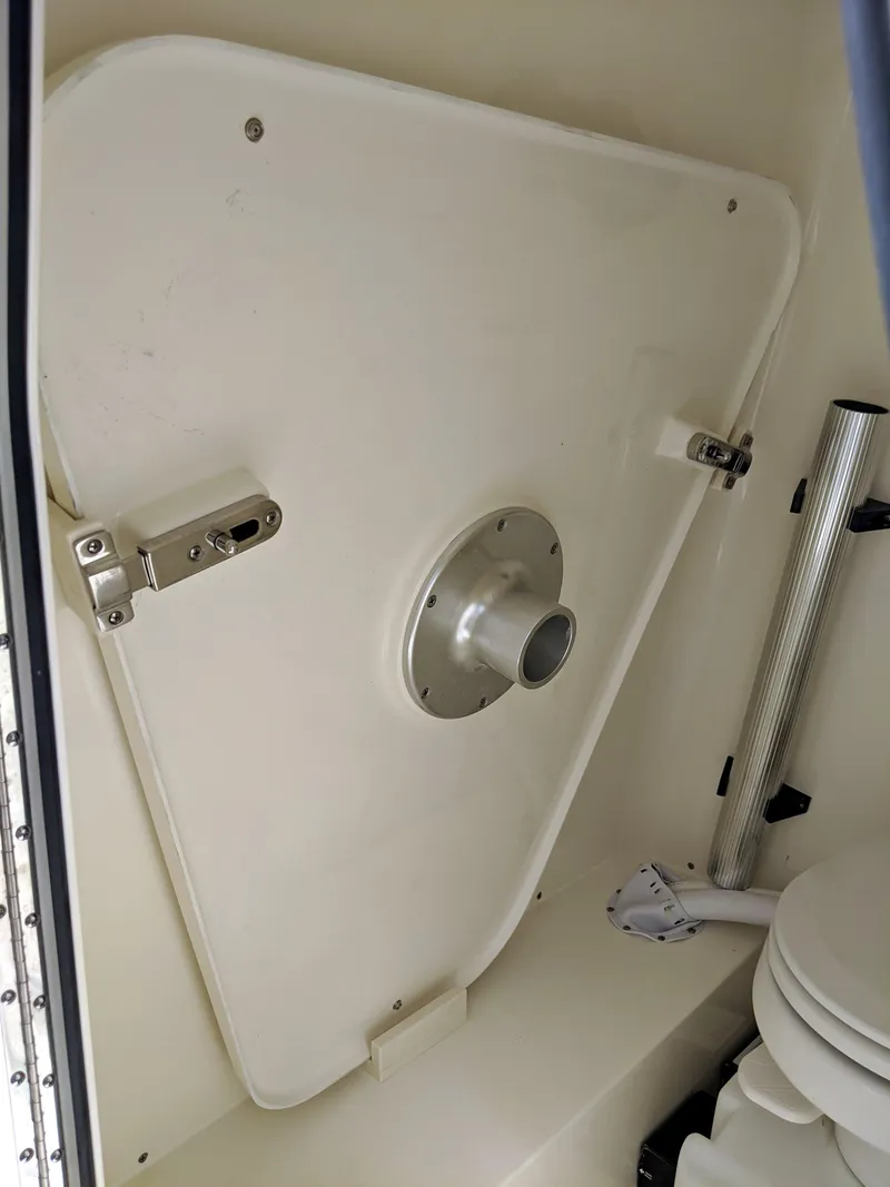 Slide: The Image of 2021 Sea Born LX26 boat interior with storage compartment and toilet. - 21