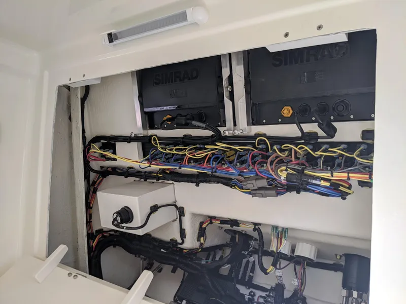 Slide: The Image of 2021 Sea Born LX26 boat wiring and electronics compartment with Simrad systems. - 22