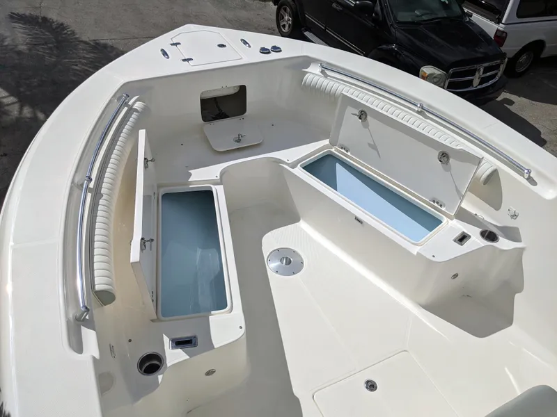 Slide: The Image of 2021 Sea Born LX26 boat interior with open storage compartments. - 27