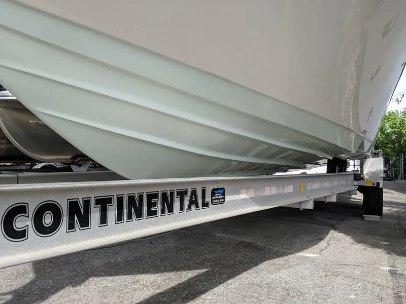 Slide: The Image of 2021 Sea Born LX26 boat on Continental trailer, close-up view of hull and trailer. - 3