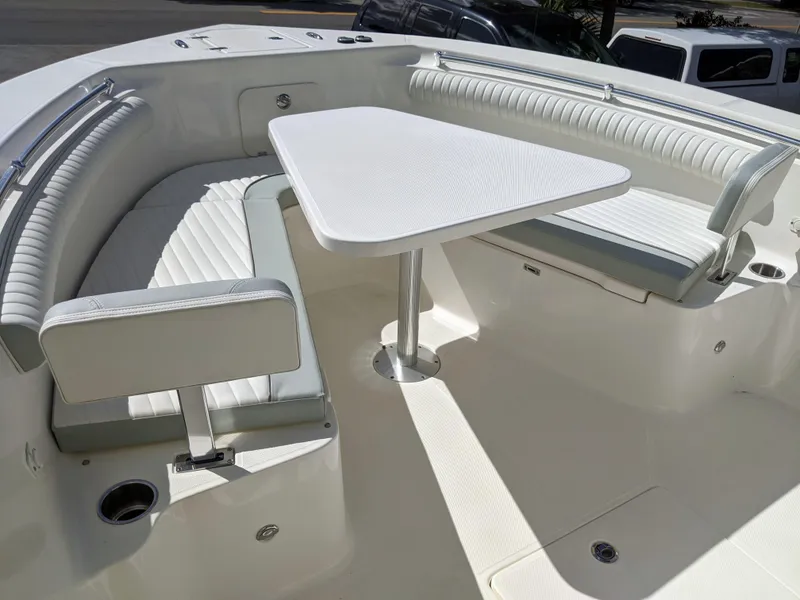 Slide: The Image of 2021 Sea Born LX26 boat interior with white seating and table. - 30