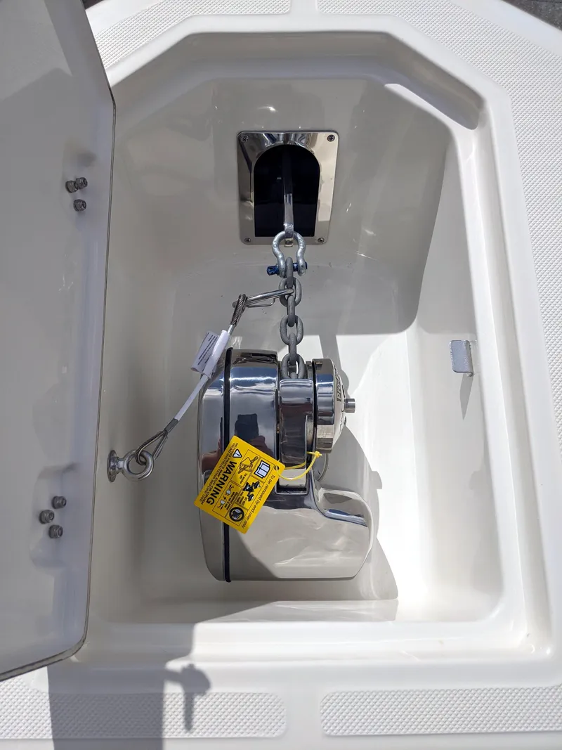 Slide: The Image of 2021 Sea Born LX26 boat anchor compartment with winch system. - 32