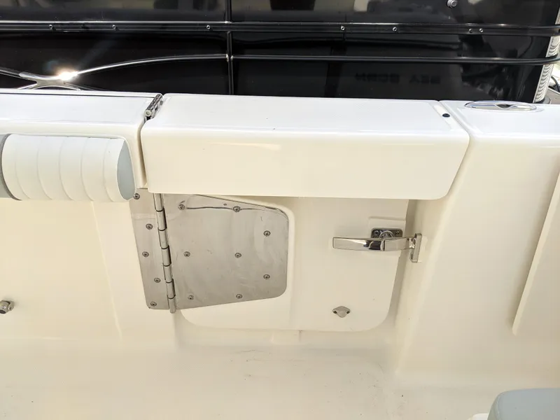 Slide: The Image of 2021 Sea Born LX26 boat interior with storage compartment and latch. - 41