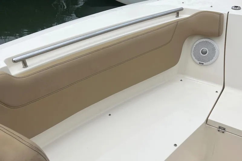 Slide: The Image of 2015 Scout 275 Dorado boat interior with beige seating and speaker. - 41