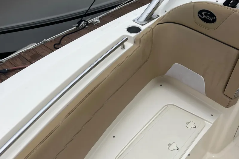 Slide: The Image of 2015 Scout 275 Dorado boat interior with tan seating and stainless steel rail. - 43