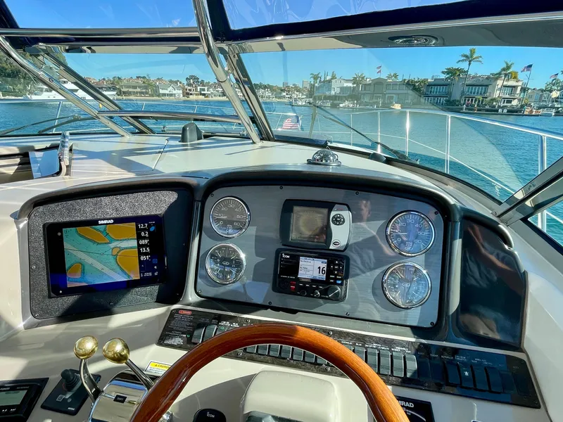 Slide: The Image of Helm of 2005 Sea Ray 390 Sundancer with navigation instruments and waterfront view. - 10