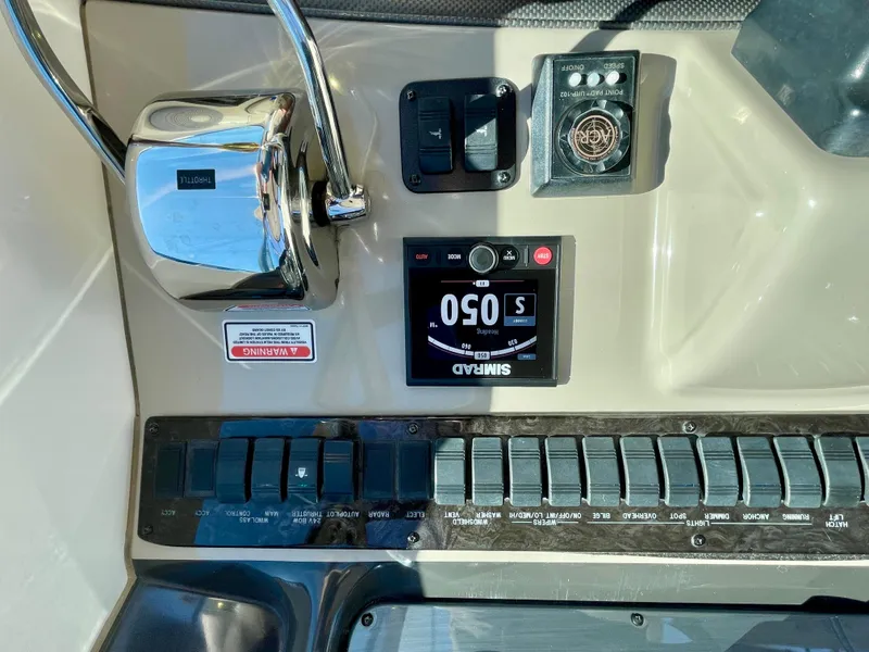 Slide: The Image of Control panel of a 2005 Sea Ray 390 Sundancer boat with various switches and gauges. - 13