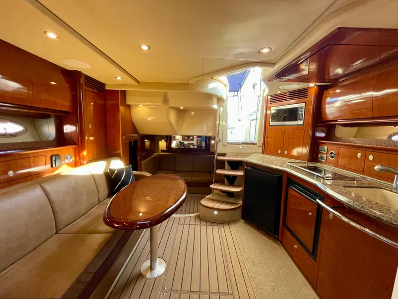 Slide: The Image of Luxurious interior of 2005 Sea Ray 390 Sundancer yacht with wood finishes and modern amenities. - 21