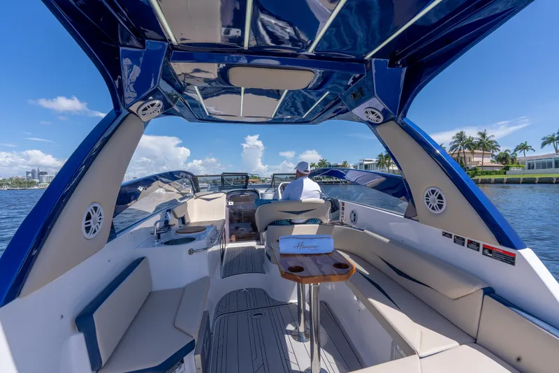 Slide: The Image of Luxurious 2025 Hanover 305 Outboard boat interior with seating and scenic water view. - 8