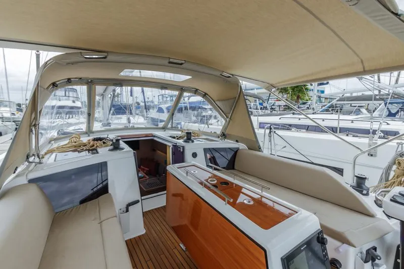 Slide: The Image of Interior view of 2023 Dufour 390 yacht with beige seating and wooden accents. - 10