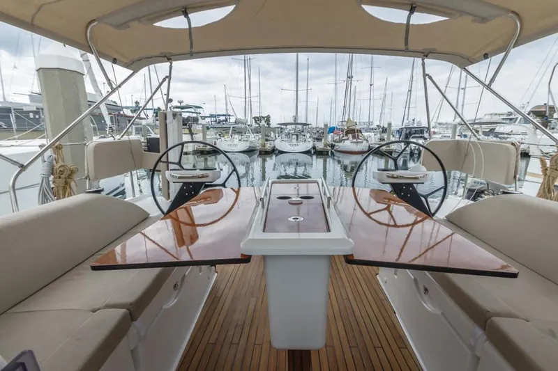 Slide: The Image of Interior view of 2023 Dufour 390 yacht with dual steering wheels and wooden deck. - 11
