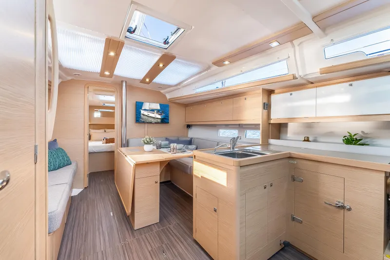 Slide: The Image of Modern interior of 2023 Dufour 390 yacht with sleek kitchen and seating area. - 14