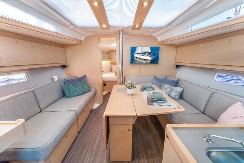 Slide: The Image of Modern interior of 2023 Dufour 390 yacht with cozy seating and dining area. - 16
