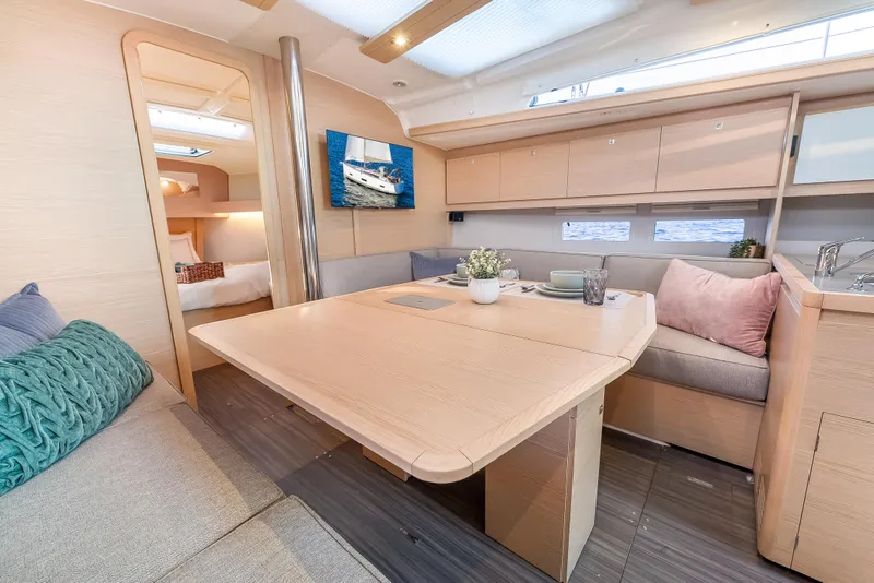 Slide: The Image of Modern interior of 2023 Dufour 390 yacht with cozy seating and dining area. - 18