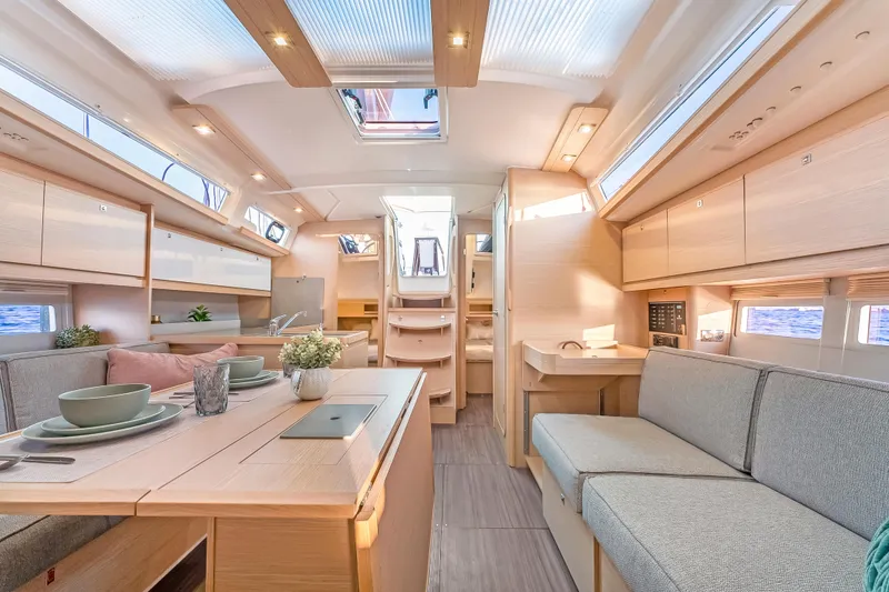 Slide: The Image of Modern interior of 2023 Dufour 390 yacht with elegant dining and seating area. - 19