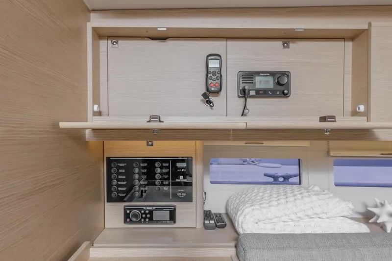 Slide: The Image of Interior of 2023 Dufour 390 yacht with navigation equipment and cozy bedding. - 21