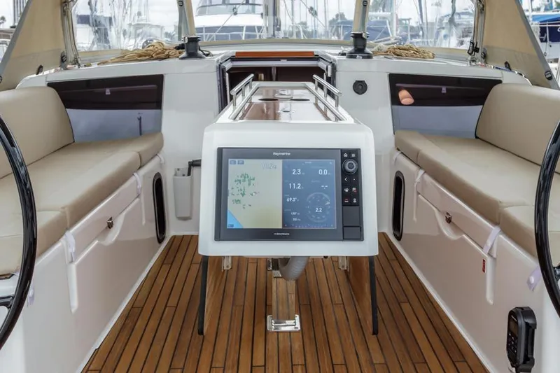 Slide: The Image of Dufour 390 yacht cockpit with navigation system, 2023 model, featuring sleek design and wooden flooring. - 8