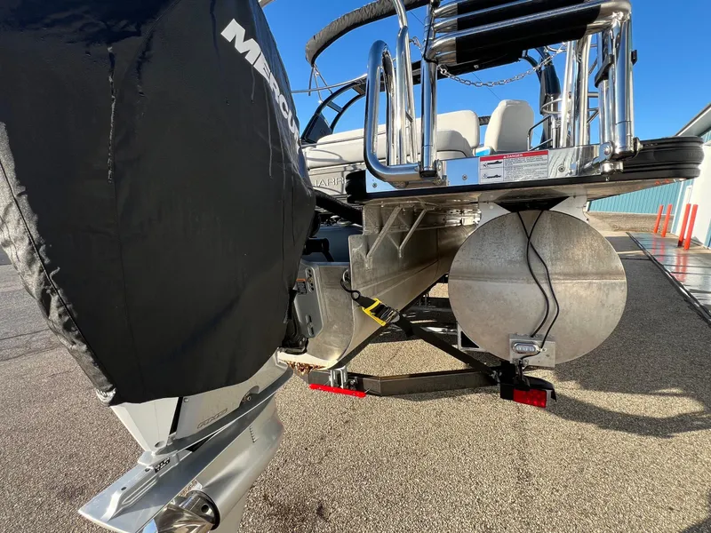 Slide: The Image of 2023 Harris Solstice 250 boat rear view with covered motor and pontoon details. - 21