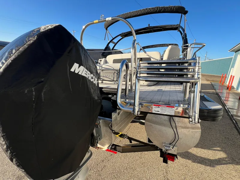 Slide: The Image of 2023 Harris Solstice 250 boat with Mercury engine, rear view, sunny day. - 22