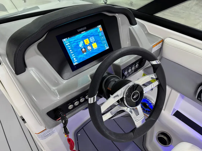 Slide: The Image of 2025 Chaparral 21 Surf boat dashboard with touchscreen and steering wheel. - 12