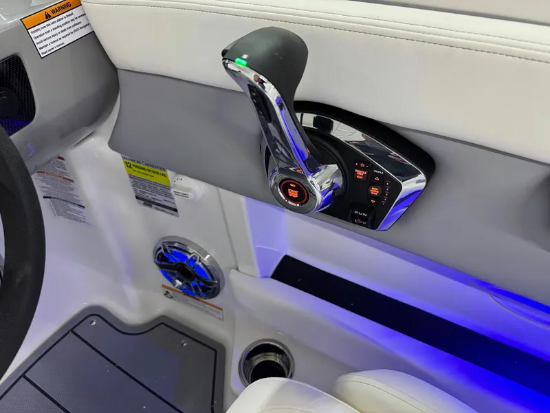 Slide: The Image of Interior of 2025 Chaparral 21 Surf boat with control lever and blue LED lighting. - 13